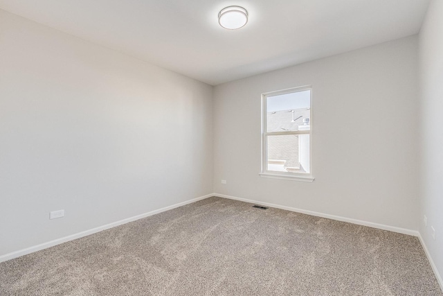 carpeted empty room with baseboards and visible vents