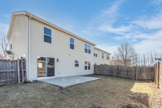 back of house with a patio area, a fenced backyard, and a lawn