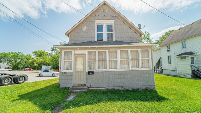 rear view of house featuring a yard