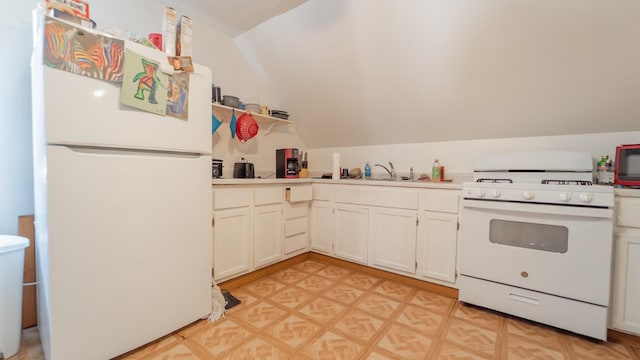 kitchen featuring white appliances, light countertops, vaulted ceiling, and white cabinetry