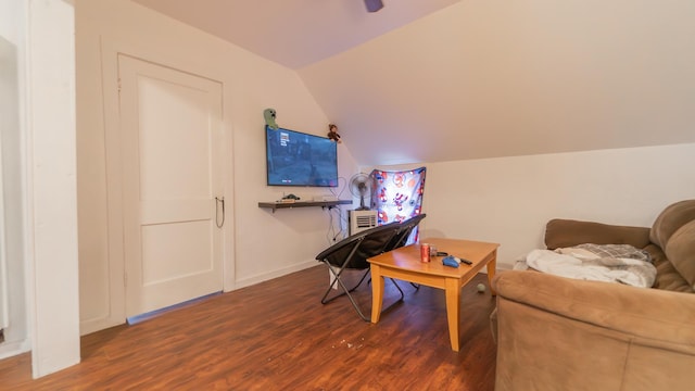 sitting room featuring baseboards, vaulted ceiling, and wood finished floors