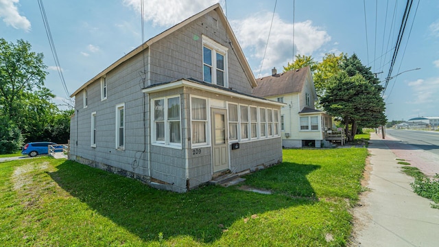 view of side of home with a lawn