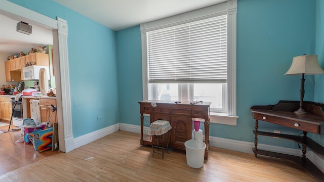 living area with light wood finished floors and baseboards