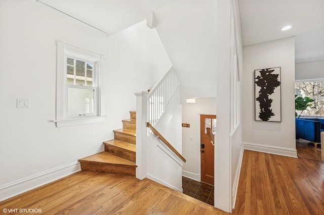 staircase featuring recessed lighting, baseboards, and wood finished floors