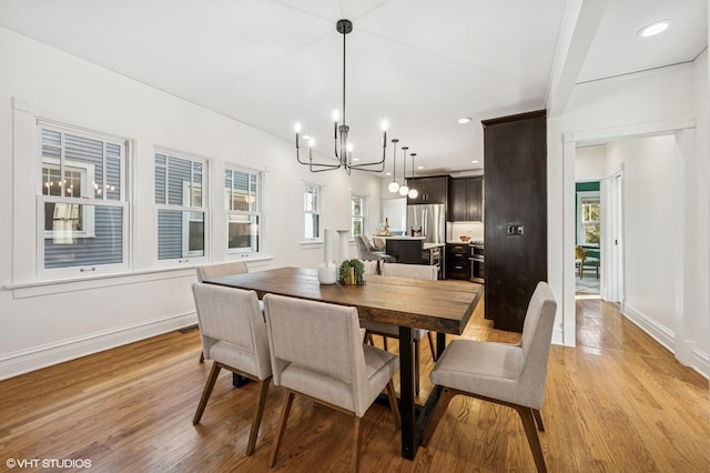 dining area with an inviting chandelier, recessed lighting, baseboards, and light wood-style floors