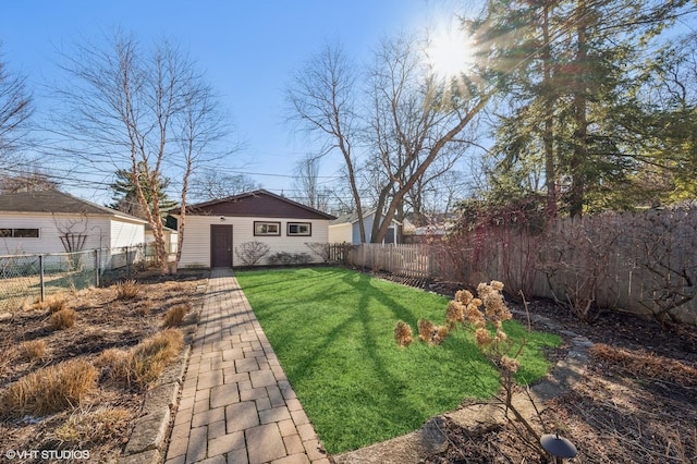 view of yard with an outdoor structure and a fenced backyard