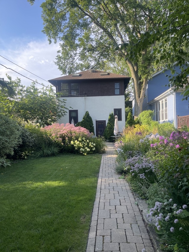 rear view of property featuring a yard