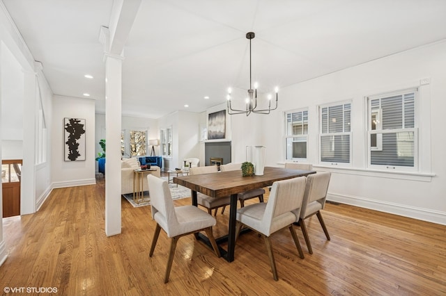 dining room with recessed lighting, light wood-type flooring, baseboards, and decorative columns