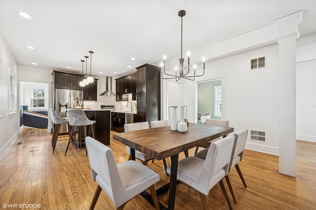 dining area with light wood-type flooring, visible vents, baseboards, and recessed lighting