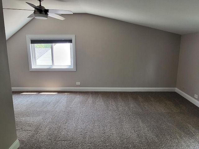 additional living space featuring a ceiling fan, carpet, lofted ceiling, and baseboards