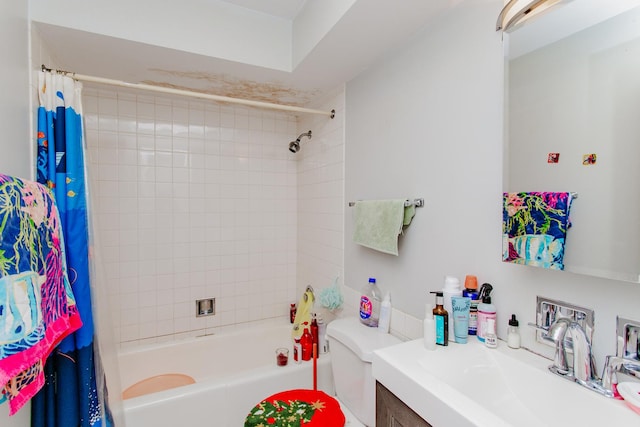 bathroom with vanity, shower / tub combo, and toilet
