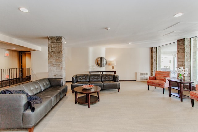 living area with radiator heating unit, light colored carpet, recessed lighting, and baseboards