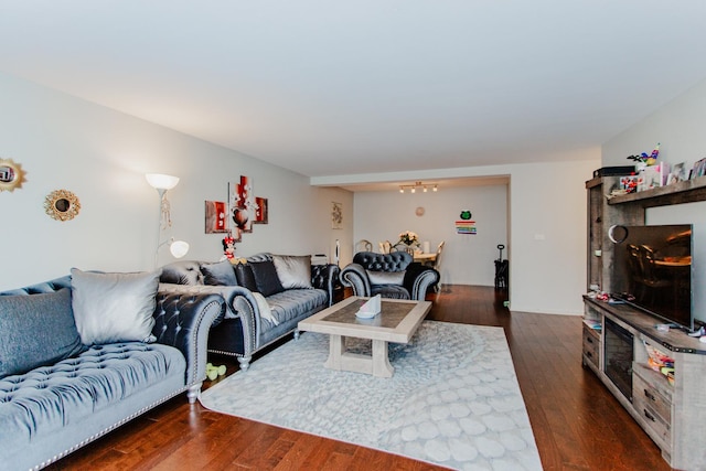 living room featuring a chandelier and wood finished floors