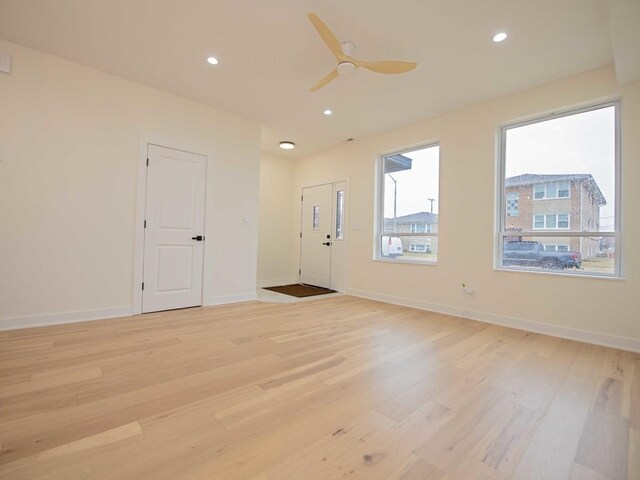 unfurnished room with baseboards, light wood finished floors, and recessed lighting