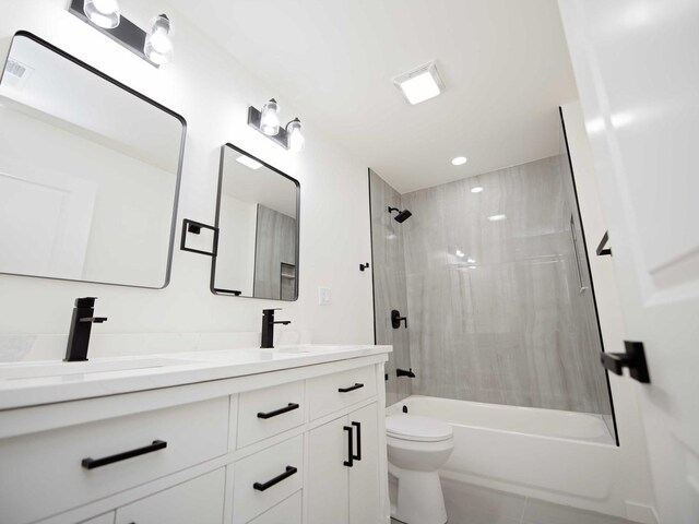 bathroom with double vanity, toilet, tile patterned floors, shower / washtub combination, and a sink