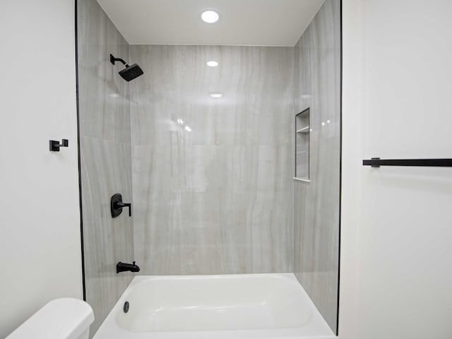 bathroom with shower / bathing tub combination and toilet