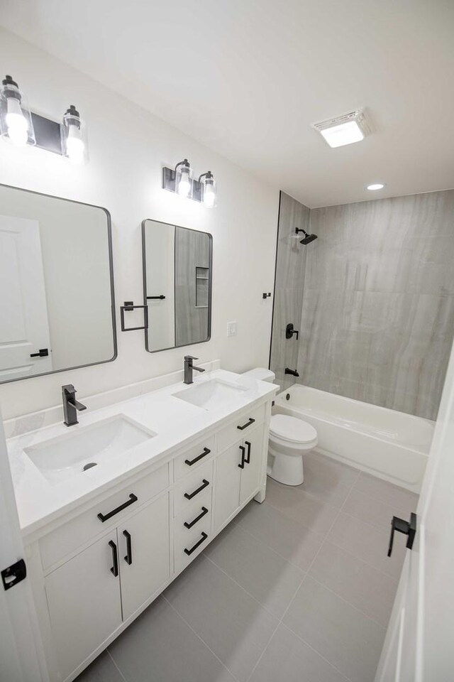 full bathroom with double vanity, shower / washtub combination, tile patterned flooring, and a sink