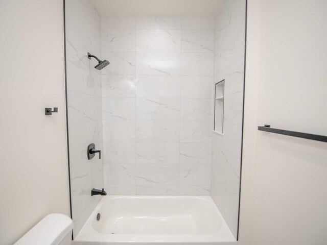 bathroom with toilet and  shower combination