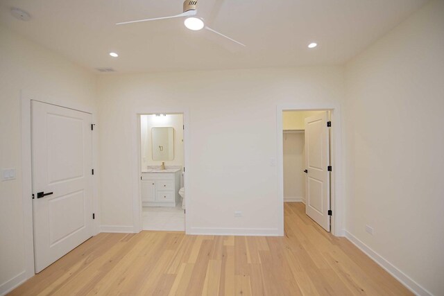 unfurnished bedroom with recessed lighting, light wood-type flooring, ensuite bath, and baseboards