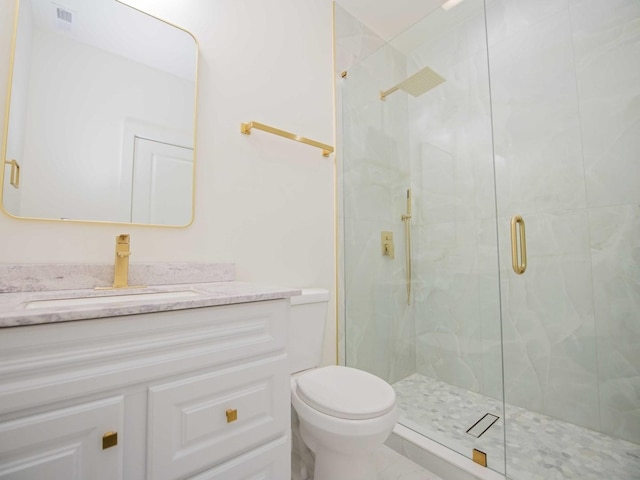 full bath featuring toilet, a marble finish shower, visible vents, and vanity