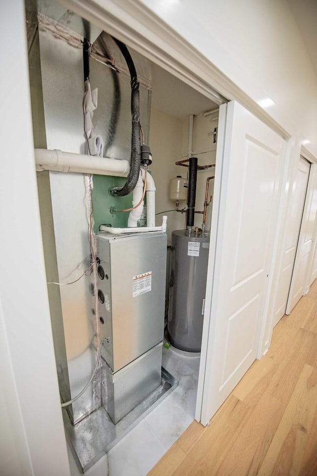 utility room featuring water heater