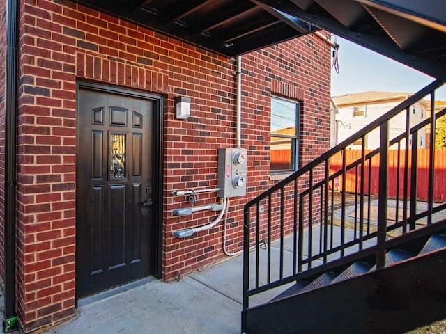 view of exterior entry with brick siding