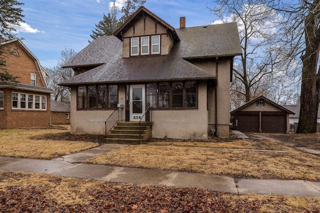 view of front of property with entry steps, roof with shingles, a chimney, and stucco siding