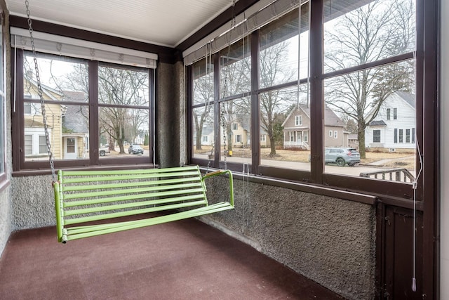 sunroom / solarium featuring a residential view