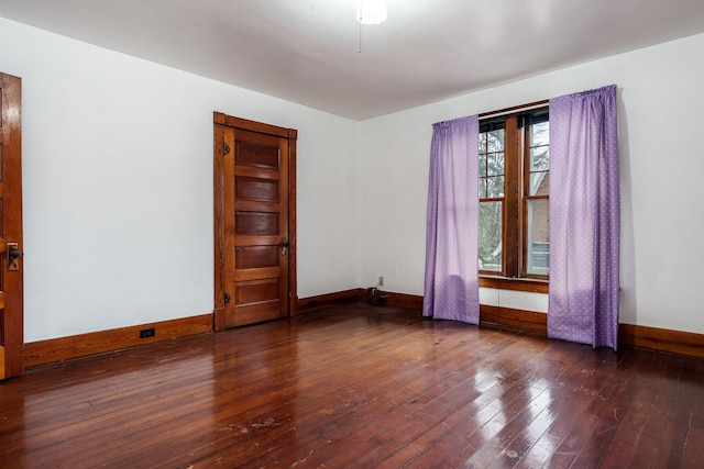 unfurnished room featuring baseboards and hardwood / wood-style floors