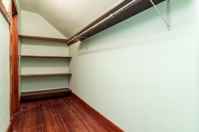 spacious closet with lofted ceiling and hardwood / wood-style floors