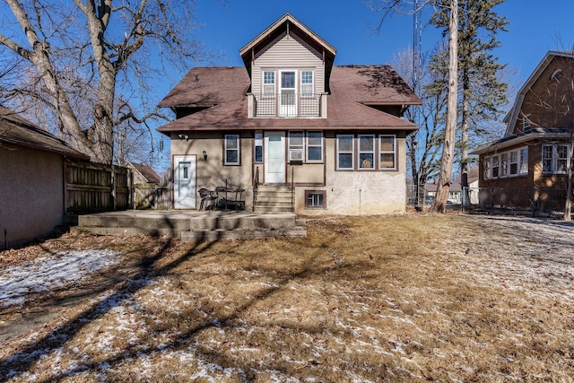 back of property with a patio, stucco siding, entry steps, fence, and a balcony