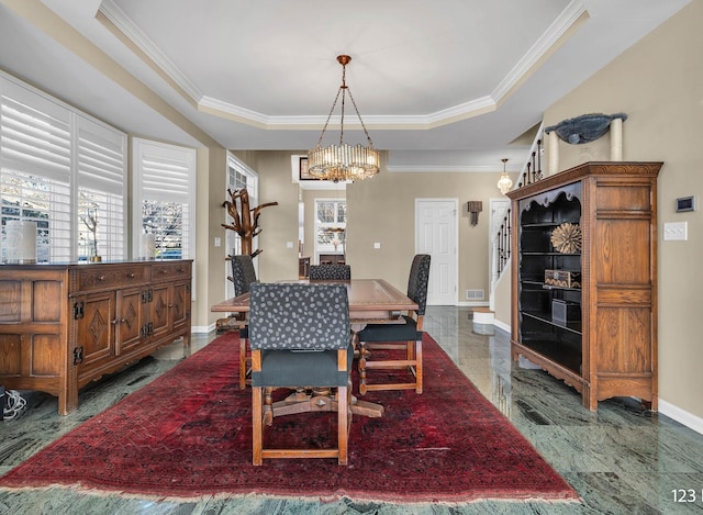 dining area featuring baseboards, marble finish floor, an inviting chandelier, a raised ceiling, and crown molding