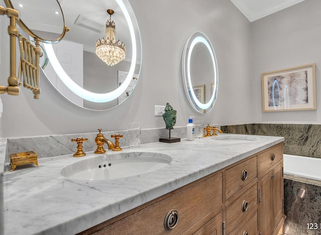 bathroom with double vanity, a chandelier, and a sink