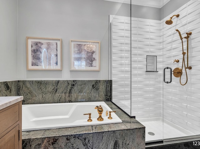 full bathroom featuring a stall shower, vanity, and a bath