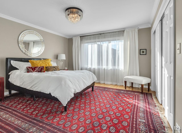 bedroom featuring wood finished floors and crown molding