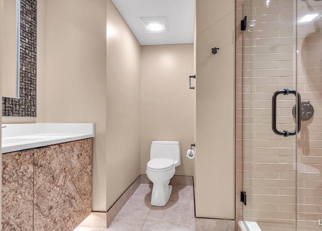 bathroom with a stall shower, baseboards, toilet, tile patterned floors, and vanity