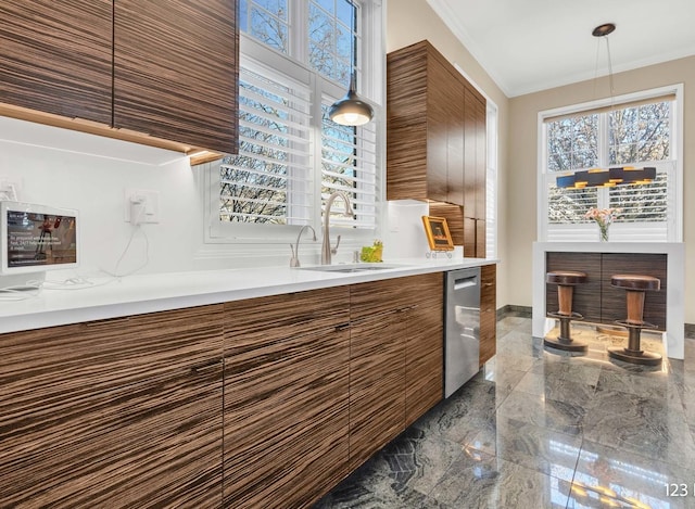 kitchen featuring dishwasher, modern cabinets, marble finish floor, and a sink