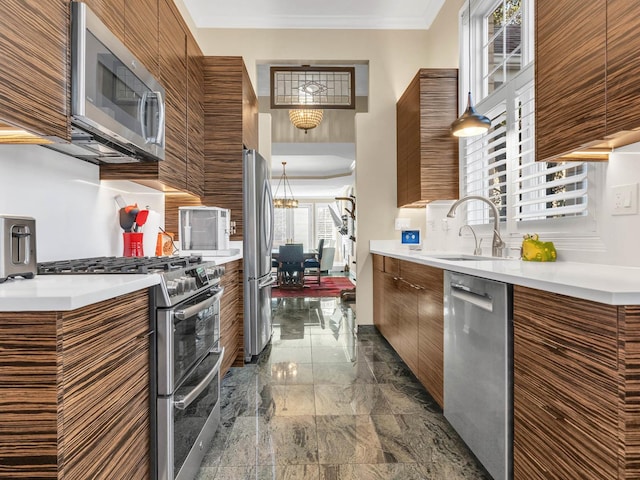 kitchen with marble finish floor, modern cabinets, appliances with stainless steel finishes, and crown molding