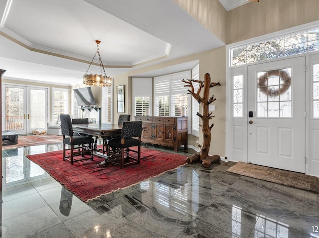 dining room featuring french doors, a raised ceiling, and crown molding