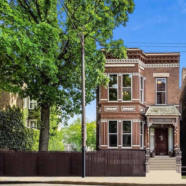 view of front of home featuring fence