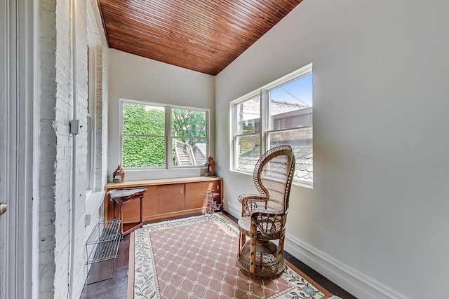 sitting room featuring wooden ceiling, baseboards, vaulted ceiling, and wood finished floors