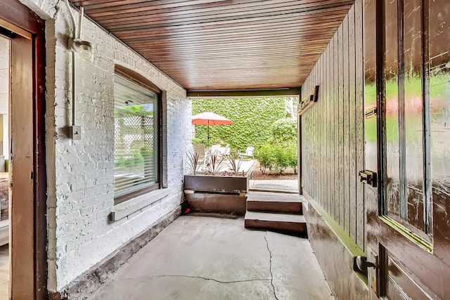 unfurnished sunroom featuring wood ceiling