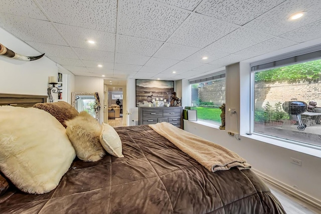 bedroom with a paneled ceiling and recessed lighting