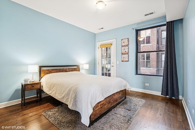 bedroom featuring visible vents, baseboards, and dark wood-style flooring