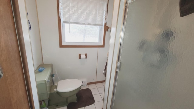 full bathroom featuring tile patterned flooring, a shower stall, and toilet