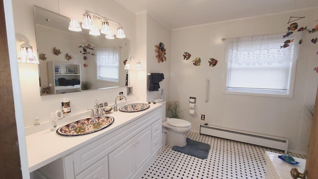 bathroom with a baseboard radiator, vanity, and toilet