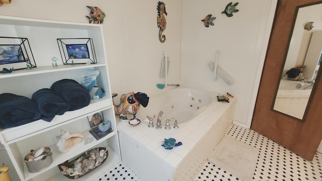 bathroom with tile patterned flooring and a tub with jets