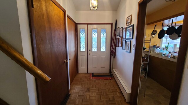 doorway to outside featuring baseboard heating