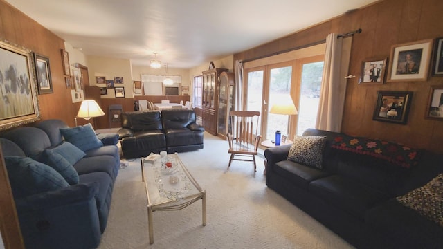 living room with carpet and wooden walls