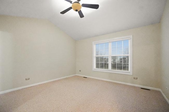 unfurnished room featuring visible vents, light carpet, vaulted ceiling, ceiling fan, and baseboards